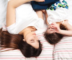 Mother and little girl sleeping together Stock Photo