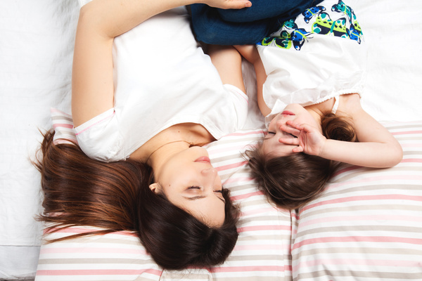 Mother and little girl sleeping together Stock Photo