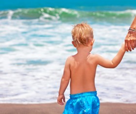 Mother holding the hands of the child Stock Photo