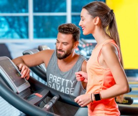 On a treadmill workout girl with coach Stock Photo 04