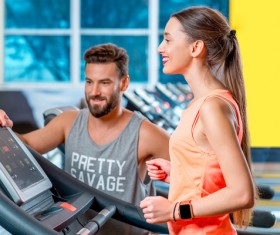 On a treadmill workout girl with coach Stock Photo 05