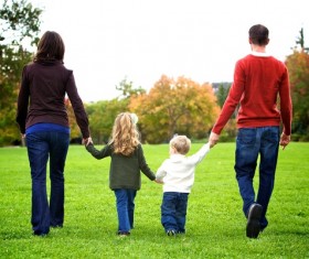 Parents walking in the park with their children Stock Photo