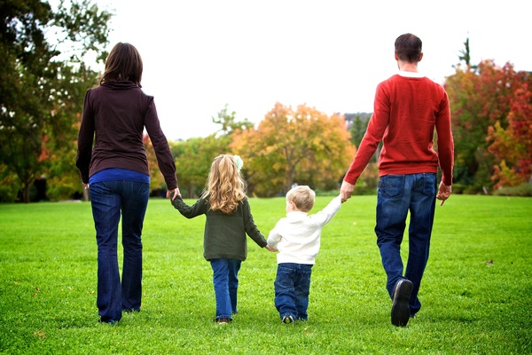 Parents walking in the park with their children Stock Photo
