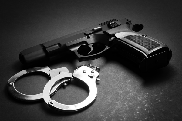 Pistols and handcuffs Stock Photo