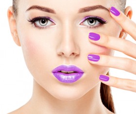 Purple nails with purple lipstick makeup girl Stock Photo