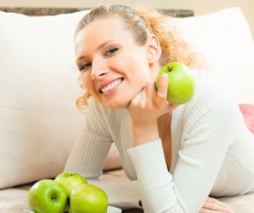 Smiling woman with green apple Stock Photo
