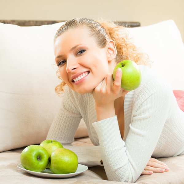 Smiling woman with green apple Stock Photo