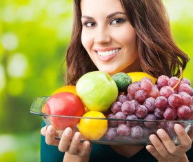 Woman carrying all kinds of fruit dish Stock Photo