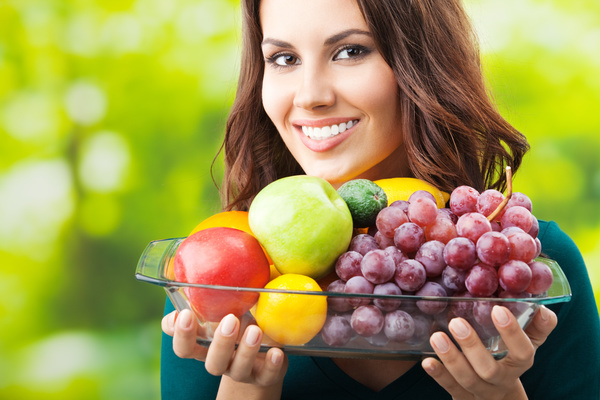 Woman carrying all kinds of fruit dish Stock Photo