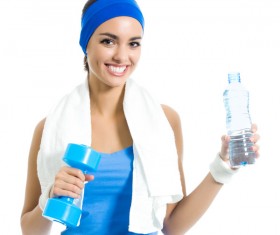 Woman holding a dumbbell and mineral water Stock Photo