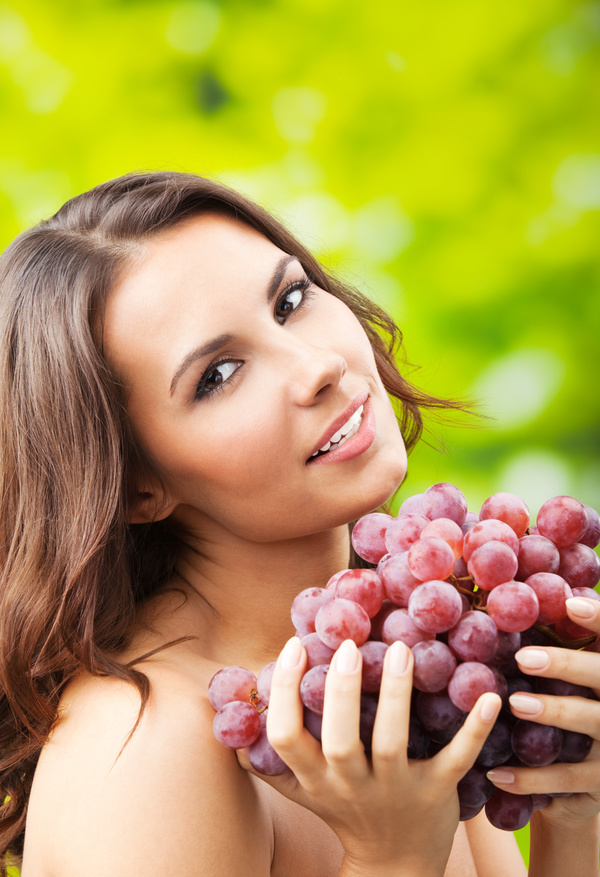 Woman holding grapes Stock Photo