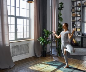Woman practicing yoga in the living room Stock Photo 04