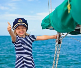 small girl with a thumbs up on a yacht Stock Photo