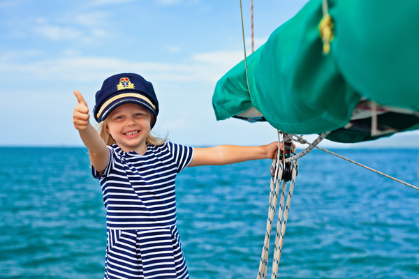 small girl with a thumbs up on a yacht Stock Photo