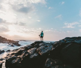 A man standing on a sea reef Stock Photo