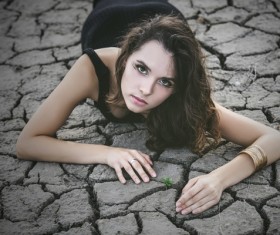 A woman lying on a dry land Stock Photo