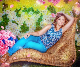 A woman lying on a rattan chair Stock Photo