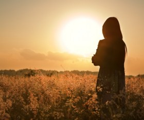 A woman standing among weeds Stock Photo