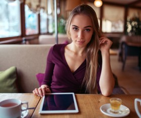 A woman who uses a tablet computer in a coffee shop Stock Photo 05