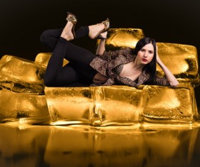 Attractive woman lying on the golden rock Stock Photo