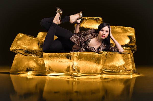 Attractive woman lying on the golden rock Stock Photo