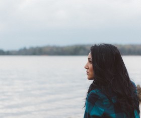 Beautiful young woman on river scene Stock Photo