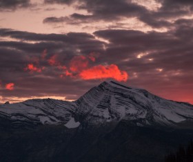 Big clouds above snowy peak Stock Photo