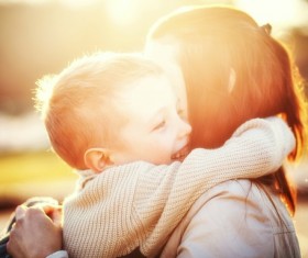 Boy hugs mother Stock Photo