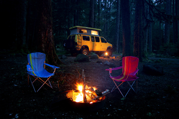 Camping bonfire and RV Stock Photo