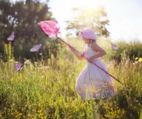 Catch the butterfly little girl Stock Photo