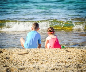 Children play in the water of the sea Stock Photo