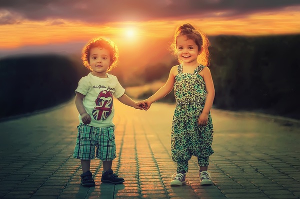 Children standing hand in hand Stock Photo