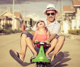 Dad and little girl driving electric toy car Stock Photo