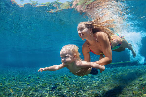 Diving mother and son Stock Photo
