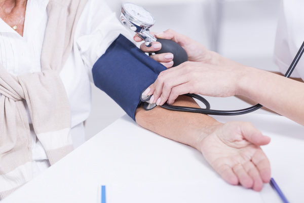 Doctors check the blood pressure for the elderly Stock Photo