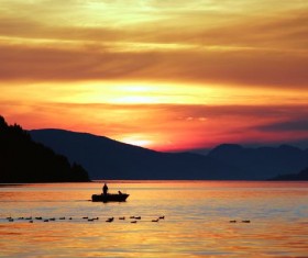 Ducks and boats on the surface of the lake Stock Photo