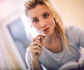 Eat biscuits for reading a woman Stock Photo
