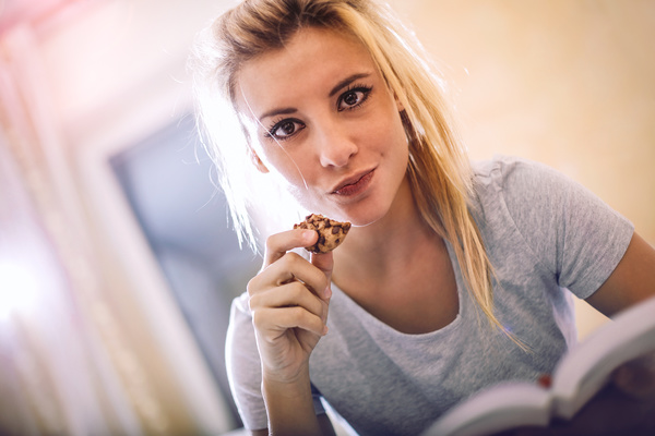 Eat biscuits for reading a woman Stock Photo
