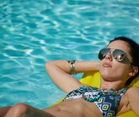 Enjoy the sunbathing woman in the pool Stock Photo 01