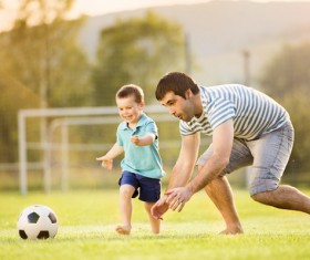 Father and son play football Stock Photo