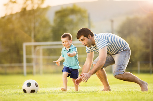 Father and son play football Stock Photo