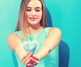 Hand holding a heart-shaped woman Stock Photo