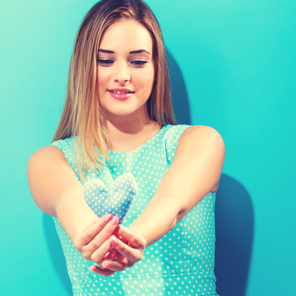 Hand holding a heart-shaped woman Stock Photo