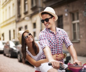 Happy couple riding a bike Stock Photo