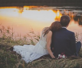 Intimate couple sitting by the river Stock Photo