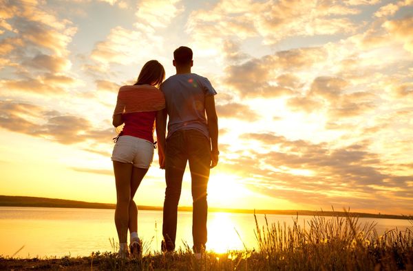 Look at the sunrise intimate couple Stock Photo