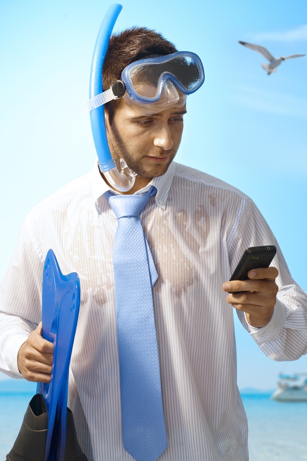 Man wearing diving equipment with phone calls Stock Photo