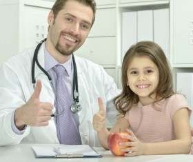Pediatrician doctor with child thumbs up Stock Photo