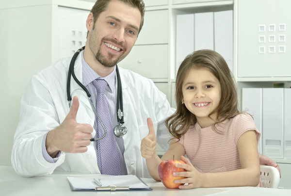 Pediatrician doctor with child thumbs up Stock Photo