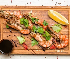 Prawns with sauce on the chopping block Stock Photo